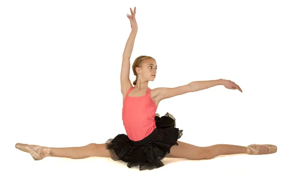 Elegant young ballerina doing the splits with arms up — Stock Photo, Image
