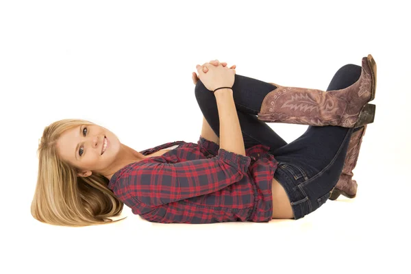 Happy female model laying down wearing cowboy boots — Stock Photo, Image