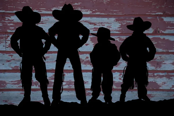 Silhouet van vier cowboys met schuur hout achtergrond — Stockfoto