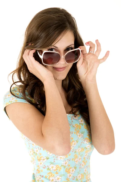 A beautiful female model peering over her sunglasses — Stock Photo, Image