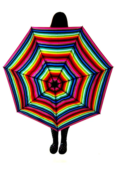 Silueta de una mujer con un paraguas de arco iris —  Fotos de Stock