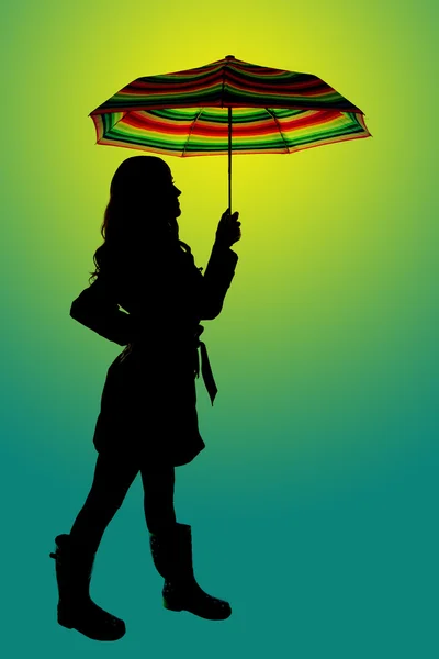 Fun background silhouette of a woman holding a colorful umbrella — Stock Photo, Image
