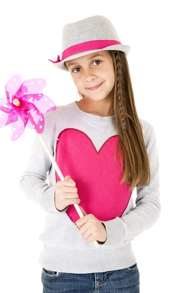 Cute girl model holding a toy pinwheel smiling — Stock Photo, Image