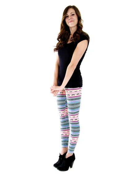 Pretty female model standing straight up in colorful leggins — Stock Photo, Image