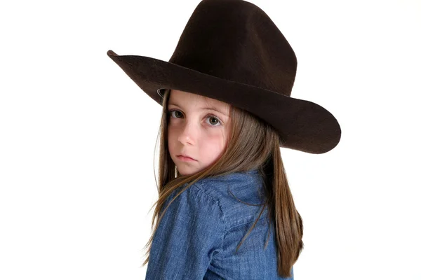 Unga cowgirl ser över hennes axel med en dyster blick — Stockfoto