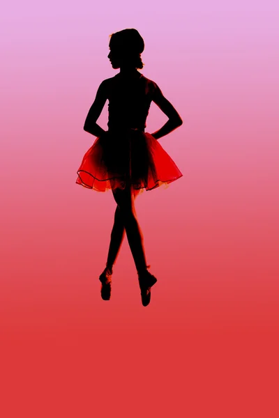 Silhouette of a young ballerina floating with a red background — Stock Photo, Image