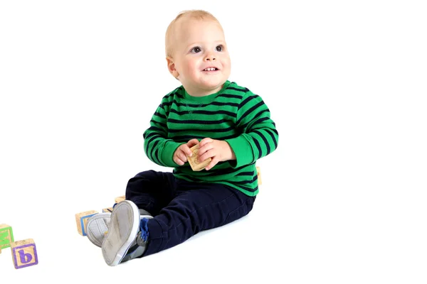 Cute young toddler boy holding a toy alphabet block — Stock Photo, Image