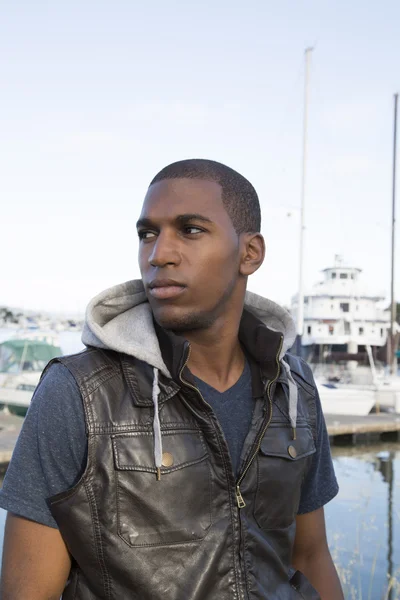 Black male looking far off at the boat marina — Stock Photo, Image