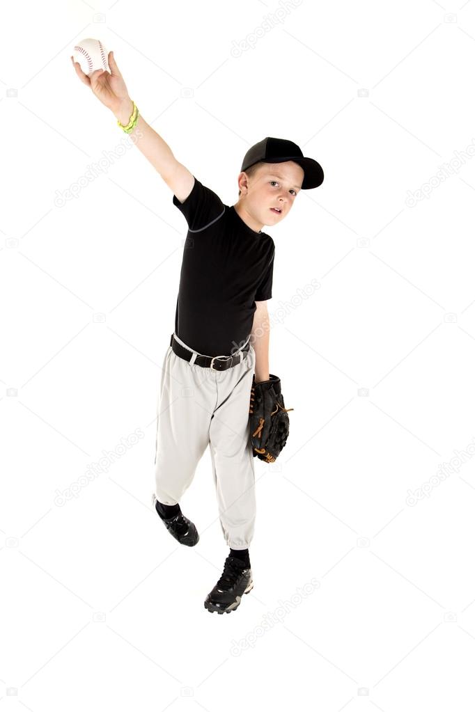 young boy in uniform pitching a baseball right handed