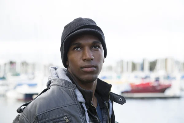 Black male model looking up at a marina — Stock Photo, Image