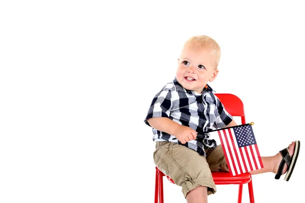 Niño de un año sosteniendo una bandera americana sentado —  Fotos de Stock