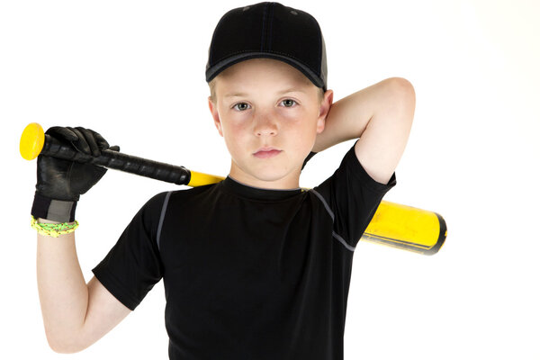 Young boy baseball player holding his bat with a serious express