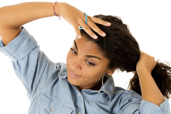 Attractive dark complected teen girl pulling hair into ponytail — Stock Photo, Image