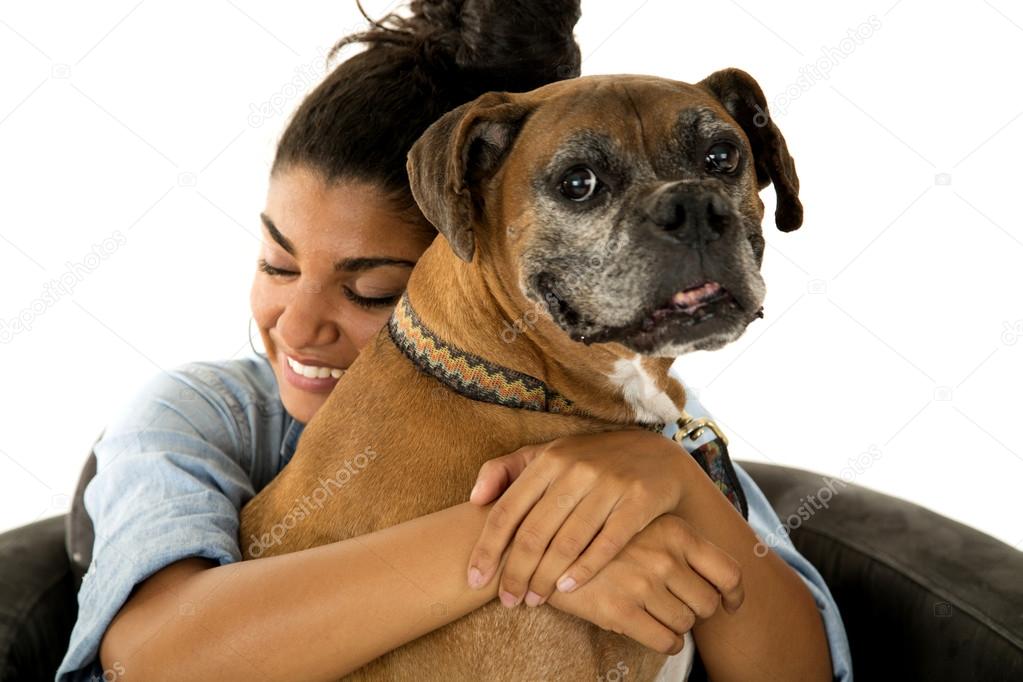 cute teenage girl hugging her dog a boxer
