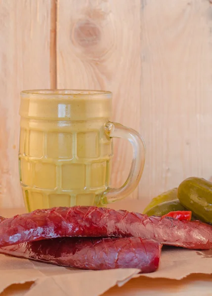 Mustard sausage dill pickle on paper — Stock Photo, Image