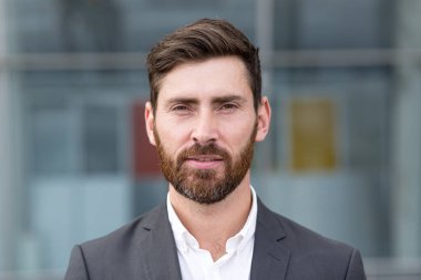 Serbest çalışan ciddi bir adam, kameraya bakıyor, takım elbiseli bir adamın yakın plan portresi.