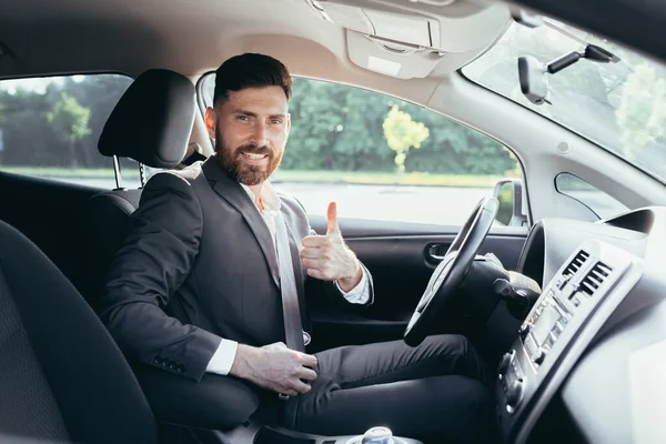 Businessman Shows Thumbs Looks Camera Smile Urges Pinch Use Seat — Stock Photo, Image