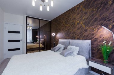 Interior of a modern bedroom with a large bed