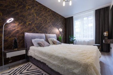 Interior of a modern bedroom with a large bed
