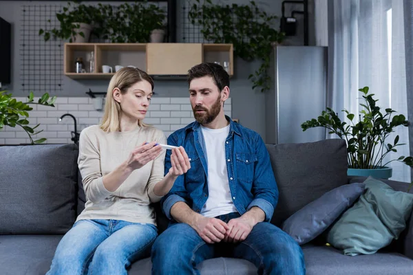 Sad Man Woman Sitting Couch Disappointed Negative Pregnancy Test — Foto de Stock