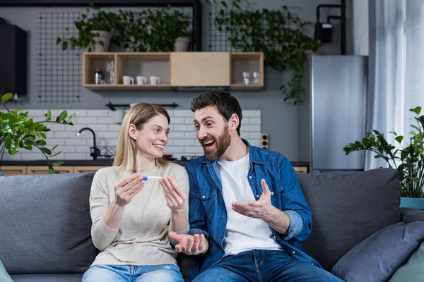 Happy Couple Man Woman Couch Sitting Rejoicing Positive Pregnancy Test — Foto de Stock