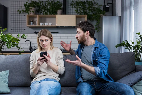 Jealous Man Shouting Woman Phone Married Couple Quarreling Home Sitting — Stock Photo, Image