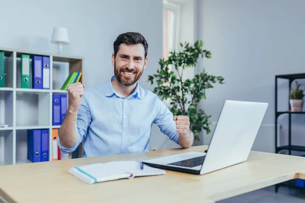 Successful Businessman Beard Looks Camera Smiles Celebrates Triumph Works Laptop — Foto de Stock