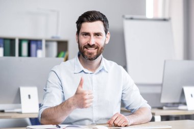 Mutlu ve başarılı iş adamı web kamerasına bakıyor ve iş arkadaşlarıyla konuşuyor. Online toplantı, mutlu gülümsemeler