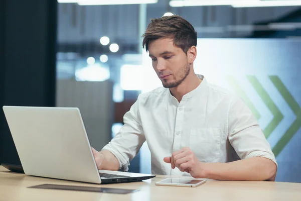 Young man thinking in office, businessman working with laptop on business plan and startup development strategy