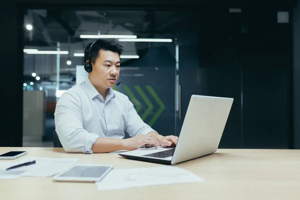 Young Handsome Asian Businessman Working Laptop Headphones Microphone Sitting Desk — Stockfoto