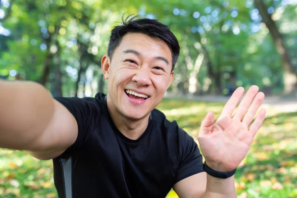 Asiatischer Sportler Herbstpark Blickt Auf Smartphone Kamera Und Lächelt Spricht — Stockfoto