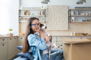 Sürpriz hediye, genç güzel Asyalı kadın bir hediye aldı Jack Russell Terrier köpeği, mutlu ve gülümseyen.