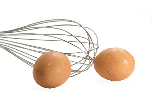 Isolated whisk with eggs — Stock Photo, Image