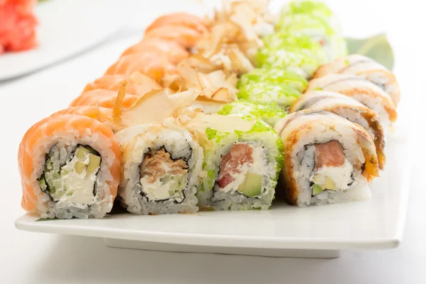 Sushi rolls on white plate — Stock Photo, Image