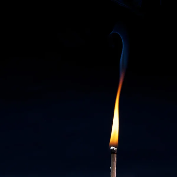 Burning row of matches against black — Stock Photo, Image