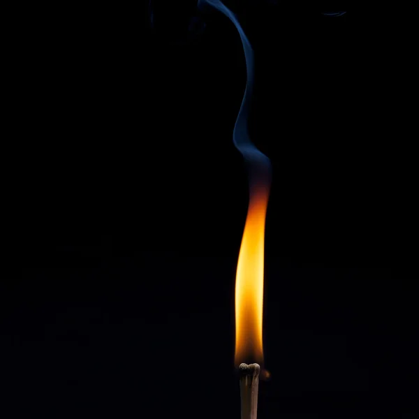 Burning row of matches against black — Stock Photo, Image