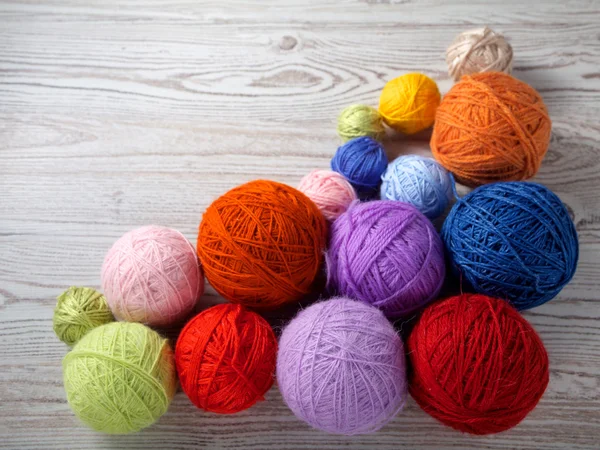 Colorful balls of yarn on a wooden table — Stock Photo, Image