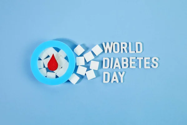 World diabetes day awareness. Blue circle with blood drop and sugar cubes. — Stock Photo, Image