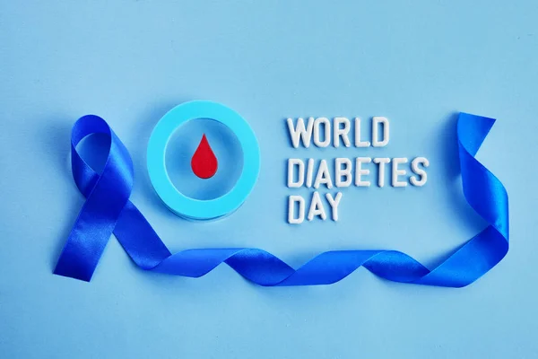 World diabetes day awareness. Blue ribbon and circle with blood drop. — Stock Photo, Image