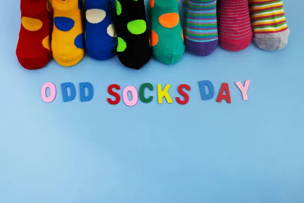 Odd Socks Day. Day lost socks, lonely socks on blue background. — Stock Photo, Image