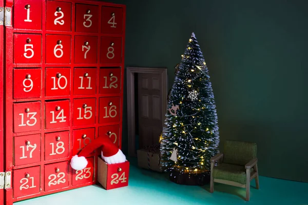 Red Christmas Advent Calendar with Santa Claus hat. — Stock Photo, Image