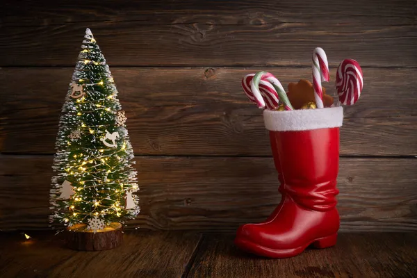 Santa boots with sweets and gifts for St. Nicholas Day on December 6th. — Stock Photo, Image
