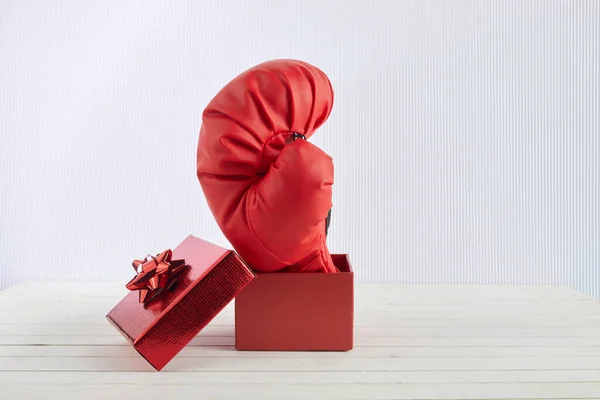 Boxing day shopping creative idea. Boxing glove coming out of gift box. — Stock Photo, Image