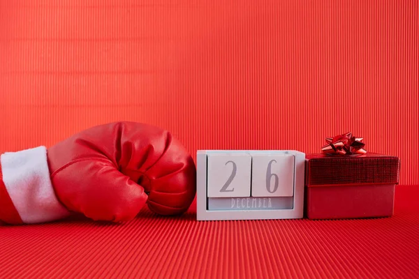 Boxing day shopping creative idea. Boxing glove with gift box and calendar. — Stock Photo, Image