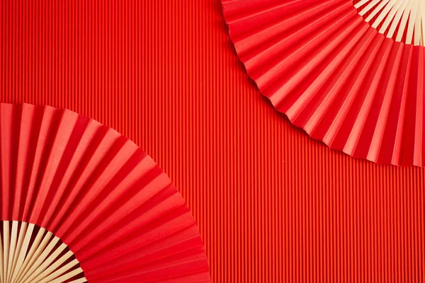 Chinese new year. Red abstract background with hand paper fan for product presentation. — Foto Stock