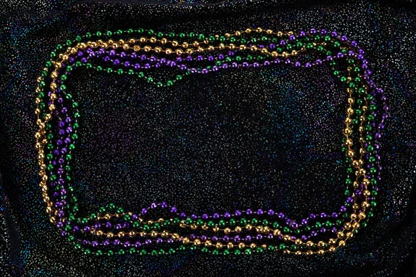 Frame of colorful Mardi Gras Beads on black background — Foto Stock