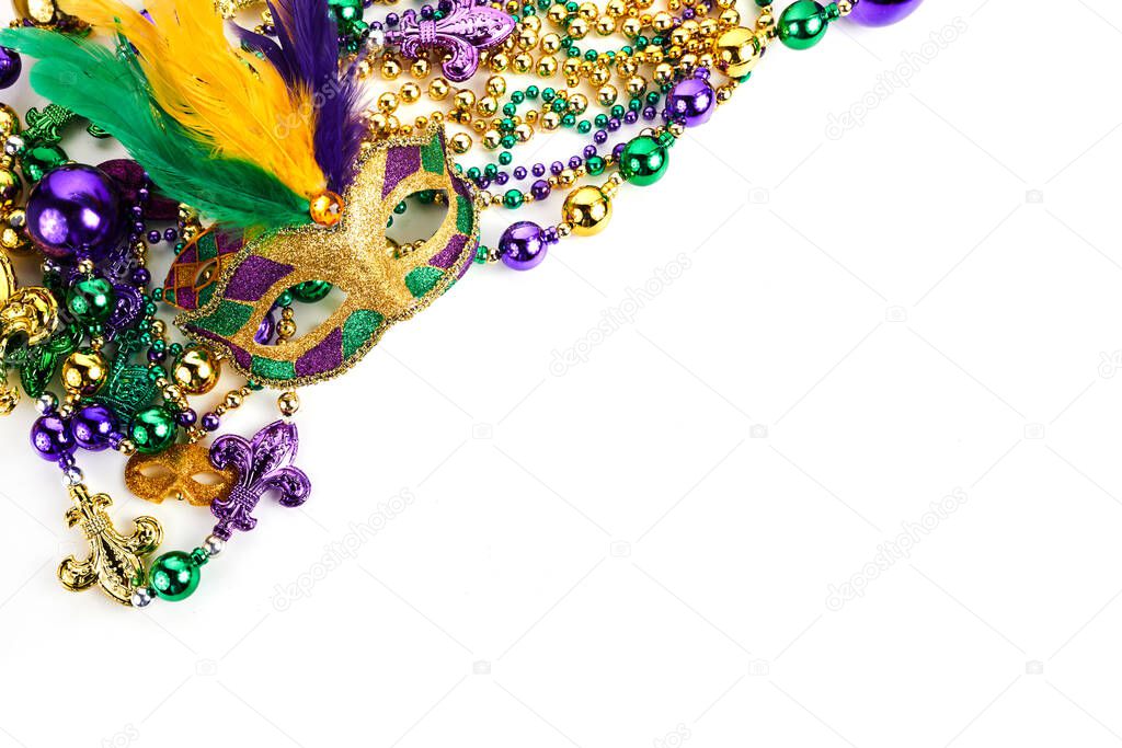 Frame of Mardi Gras mask and beads isolated on white background.