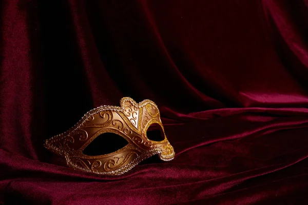 Luxury venetian mask on dark red background. Carnival masquerade fantasy mask — Stock Photo, Image