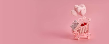 Pembe arka planda pembe alışveriş arabasında kalp şeklinde balonlar. Sezon satışı, bahar alışverişi konsepti. Sevgililer Günü.