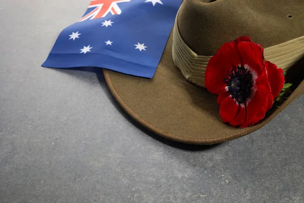 Anzac armé slouch hatt med australisk flagga och vallmo på sten bakgrund — Stockfoto